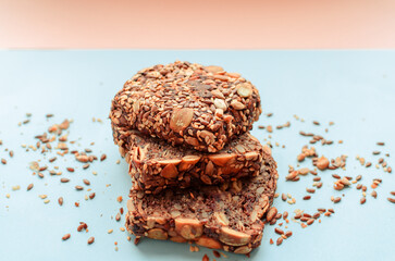Sliced whole grain bread rye with seeds flax, sunflower, pumpkin and sesame.Healthy food, eco-friendly natural products. Fresh bread on a pink background.