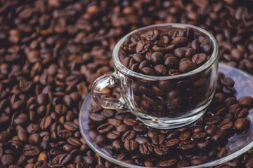 coffee beans in a cup and around the cup