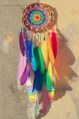 Details colorful rainbow dream catcher feathers on wall