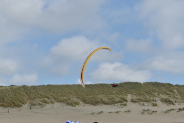 Paragliding at the beach of Katwijk aan Zee. Paraglider's making use of updraft of the dunes to stay in the air