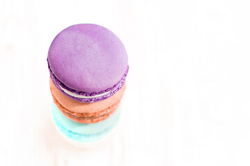 Top view of stack of French macaroons white a background. Sweet and colorful French macaroons. Dessert. Homemade sweets. Café dessert. Selective focus