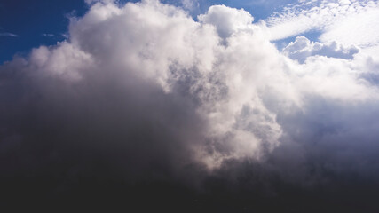 Obraz premium Aerial photo from flying drone of a many little fluffy clouds with sun rays. Amazingly beautiful sky background with copy space. Wonderful skies landscape