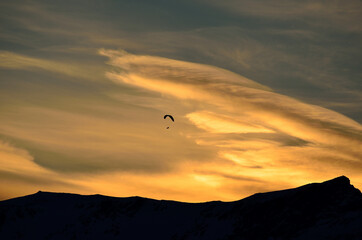 Paraglider on dawn sky
