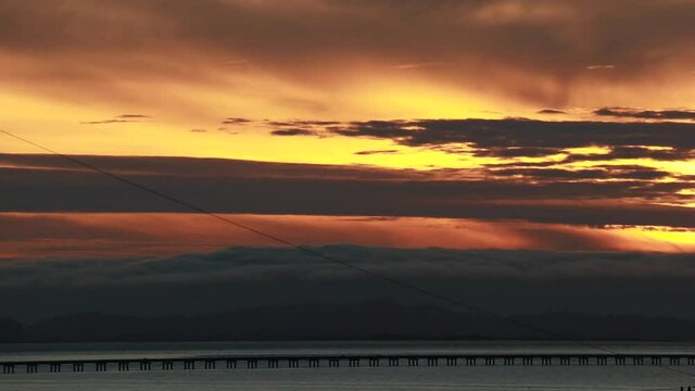 Sunset along the straight low section of Astoria Megler bridge Oregon to Washington