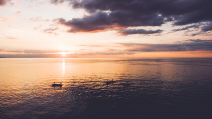 Obraz premium Aerial photo from flying drone of a beautiful nature landscape with amazing dramatic sky and sunrise over Indian Ocean in evening time. Wonderful view with colorful clouds with sunrise and seascape
