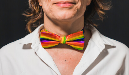 Decorative makeup with a gay pride theme. Gay pride bow tie. Lady's neck with gay pride makeup. Gay...
