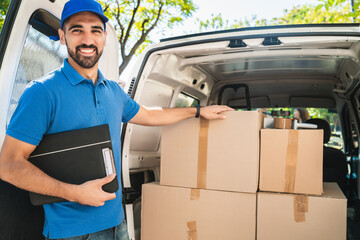 Delivery man checking the products with checklist.