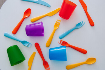 vibrant multicolored forks, kives and spoons (white background)