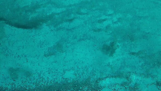 Air bubbles seethe in turquoise sea water (18). Abstract aqua background. Fast boat movement on the sea - bottom view