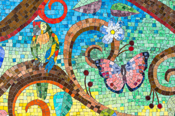 Fototapeta na wymiar Colorful mosaic artwork close-up Ceramic tiles pattern with flower and bird