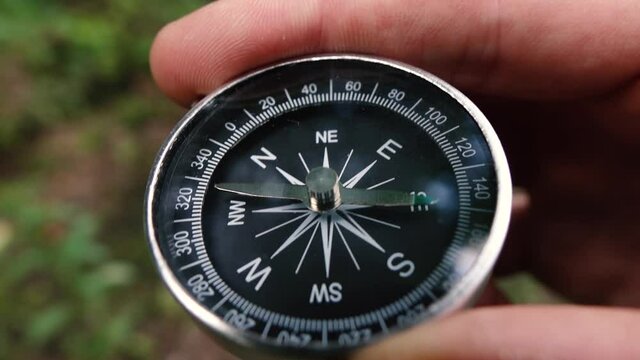 compass in the hands of a man close up