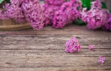 Obraz na płótnie Canvas Bouquet of lilac spring flowers on rustic old shabby wooden table. Copy space 