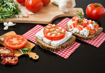 Healthy food. Vegetarian food. Italian bruschetta with White Feta Cheese with Tomatoes, Garlic and Rosemary. Cheese Vegetable Sandwich
