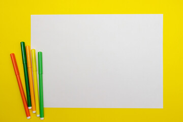 yellow and white textured background for the inscription with cardas, felt-tip pens and pens