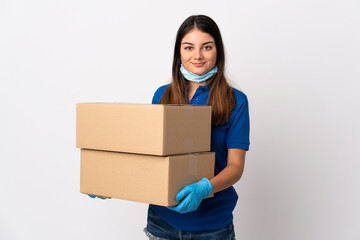 Young delivery woman protecting from the coronavirus with a mask isolated on white background smiling a lot