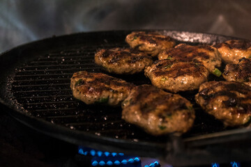 Juicy homemade meatballs from fresh meat in a grill pan. Closeup.