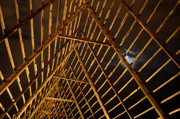 old wooden stockfish structure at night