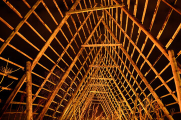 old wooden stockfish structure at night
