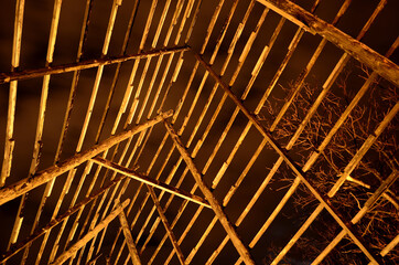 old wooden stockfish structure at night