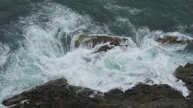 Waves Crashing into Cliff Walls