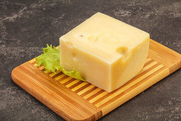 Emmental cheese over wooden board