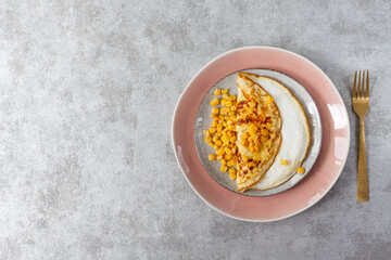 Freshly made omelet on a gray background