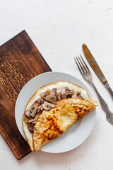 Omelet with mushrooms on a wooden board