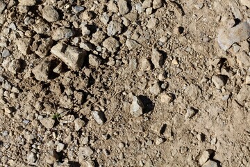 A close view of the rocks in the dusty dry dirt ground.