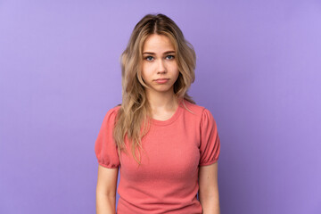 Obraz premium Teenager Russian girl isolated on purple background with sad and depressed expression