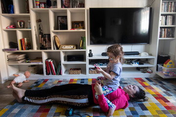 
little girl lying on her mother