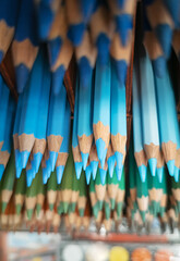 blue pencils on background of other pencils. Creativity concept. Pencils on  shelf in store.