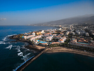 Naklejka na ściany i meble Aerial view of peninsula coastline. Big hotel resort in Playa de las Americas, Tenerife, Canary Islands, Spain. 