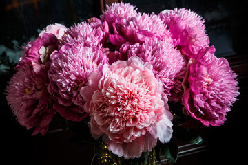 closeup elegant bouquet made from many large pink and purple peonies