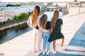 Family on rooftop enjoying with view of beautiful sunset in Sankt Petersburg in Russia