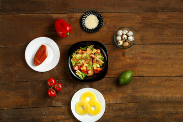 Pan-Asian salad with cherry tomatoes, smoked chicken, pineapple and sesame seeds