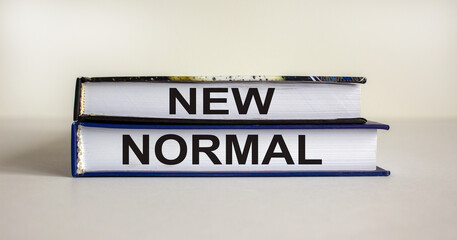 Books with text 'new normal' on beautiful white background. Business concept, copy space.