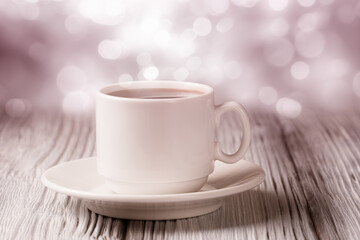 Cup of coffee over defocused lights