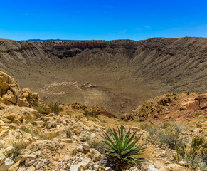 Meteorite crater near Winslow, Arizona with foreground cactus