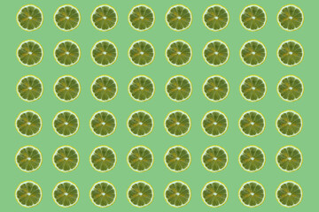 Pattern. lime slices on a green background