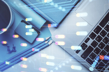 Naklejka premium Multi exposure of data drawing hologram over topview of study desk background with computer. Concept of technology.