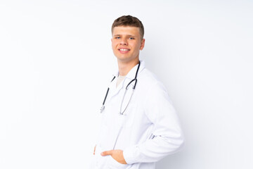 Fototapeta premium Young handsome man over isolated white background with doctor gown