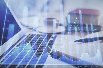 Double exposure of financial chart drawing and desktop with coffee and items on table background. Concept of forex market trading