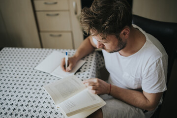 Man reading and taking notes at home in Quarantine