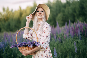 blonde girl in a dress with a basket in a field of lupins