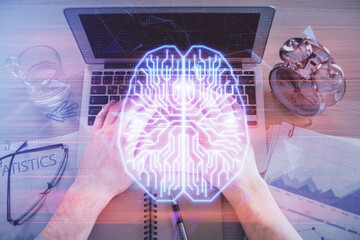 Double exposure of man's hands typing over computer keyboard and brain hologram drawing. Top view....