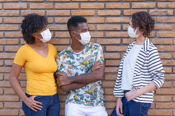 Young people talking with protective masks.