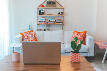 Leptop mug and cactus on home decor table.