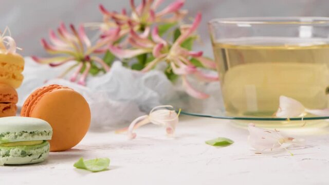 A french sweet delicacy, macaroons variety closeup. Color fresh macaroons on wooden background.