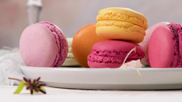 A french sweet delicacy, macaroons variety closeup. Color fresh macaroons on wooden background.