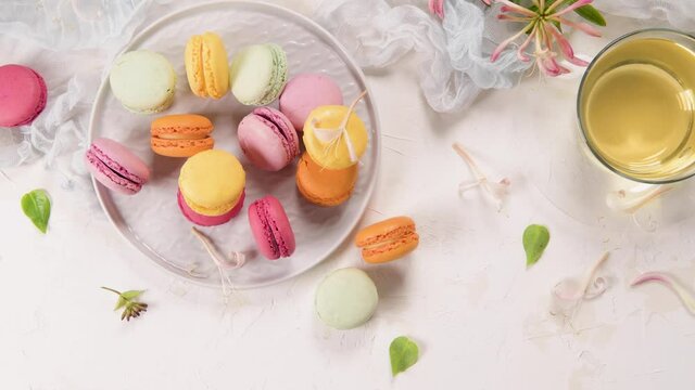 A french sweet delicacy, macaroons variety closeup. Color fresh macaroons on wooden background.